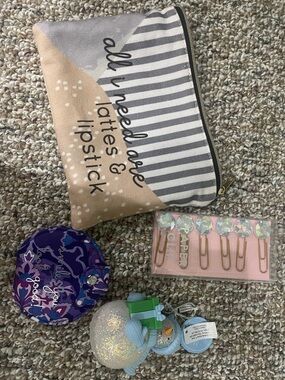 Makeup bag, decorative paper clips, compact mirror, and hand sanitizer holder